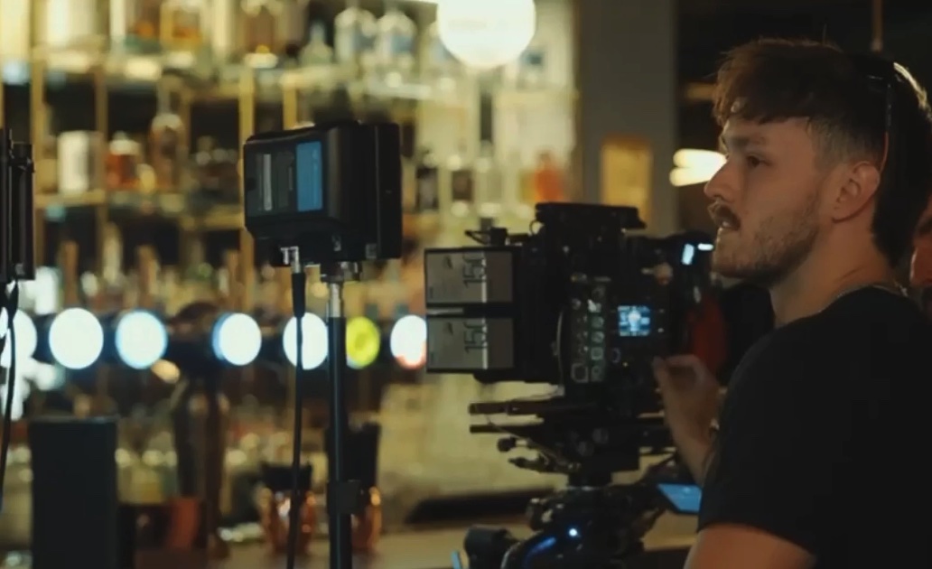Camera set up at the bar with the 1st AC at the monitor