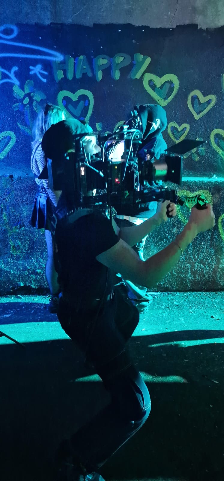Oliver operating handheld in blue light