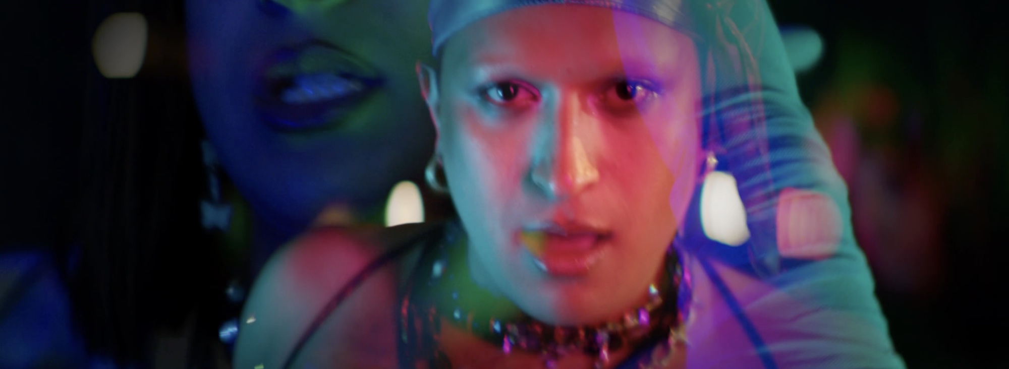 Close portrait in mixed blue, pink and green light